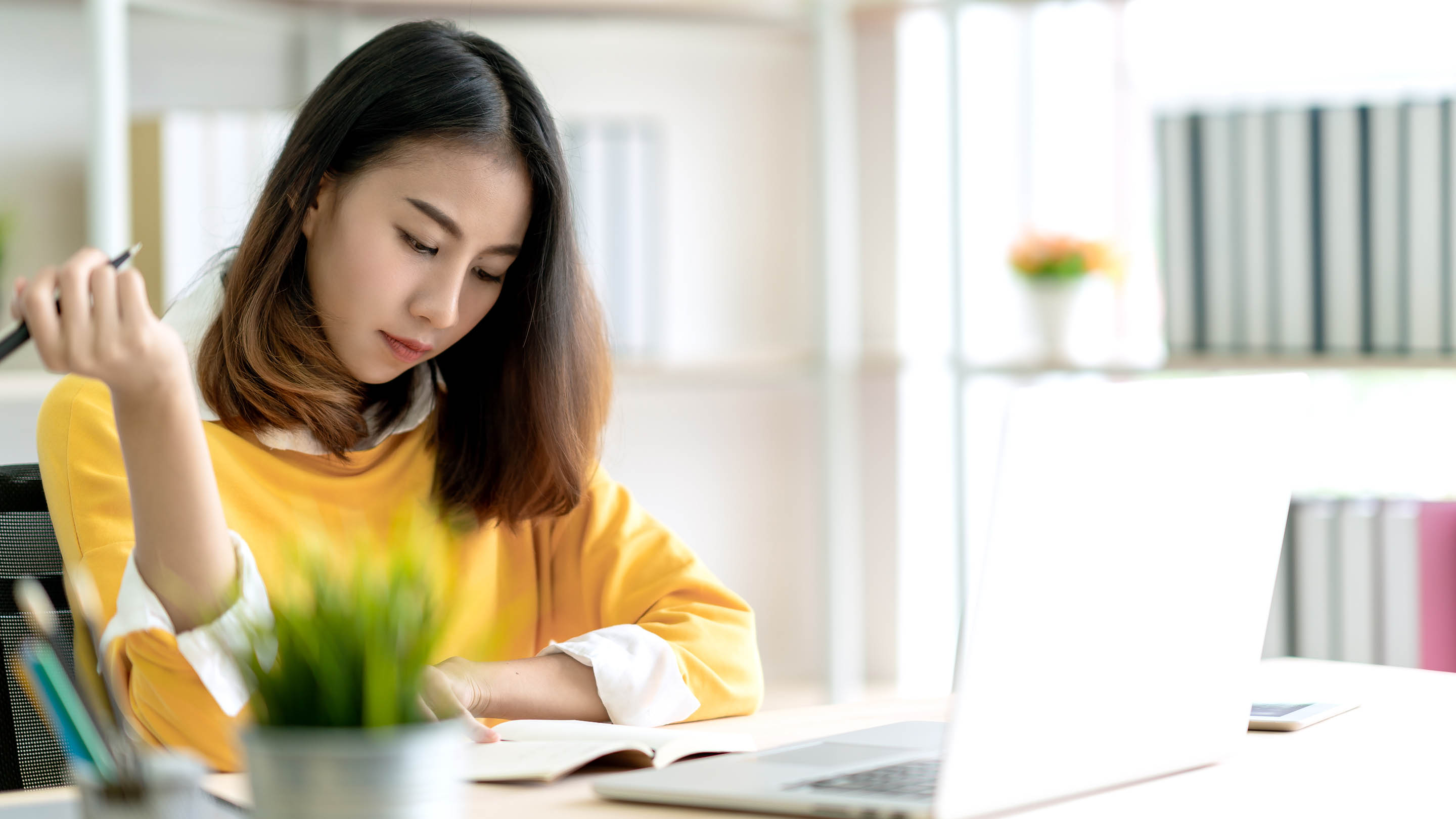 Woman working on a laptop at home